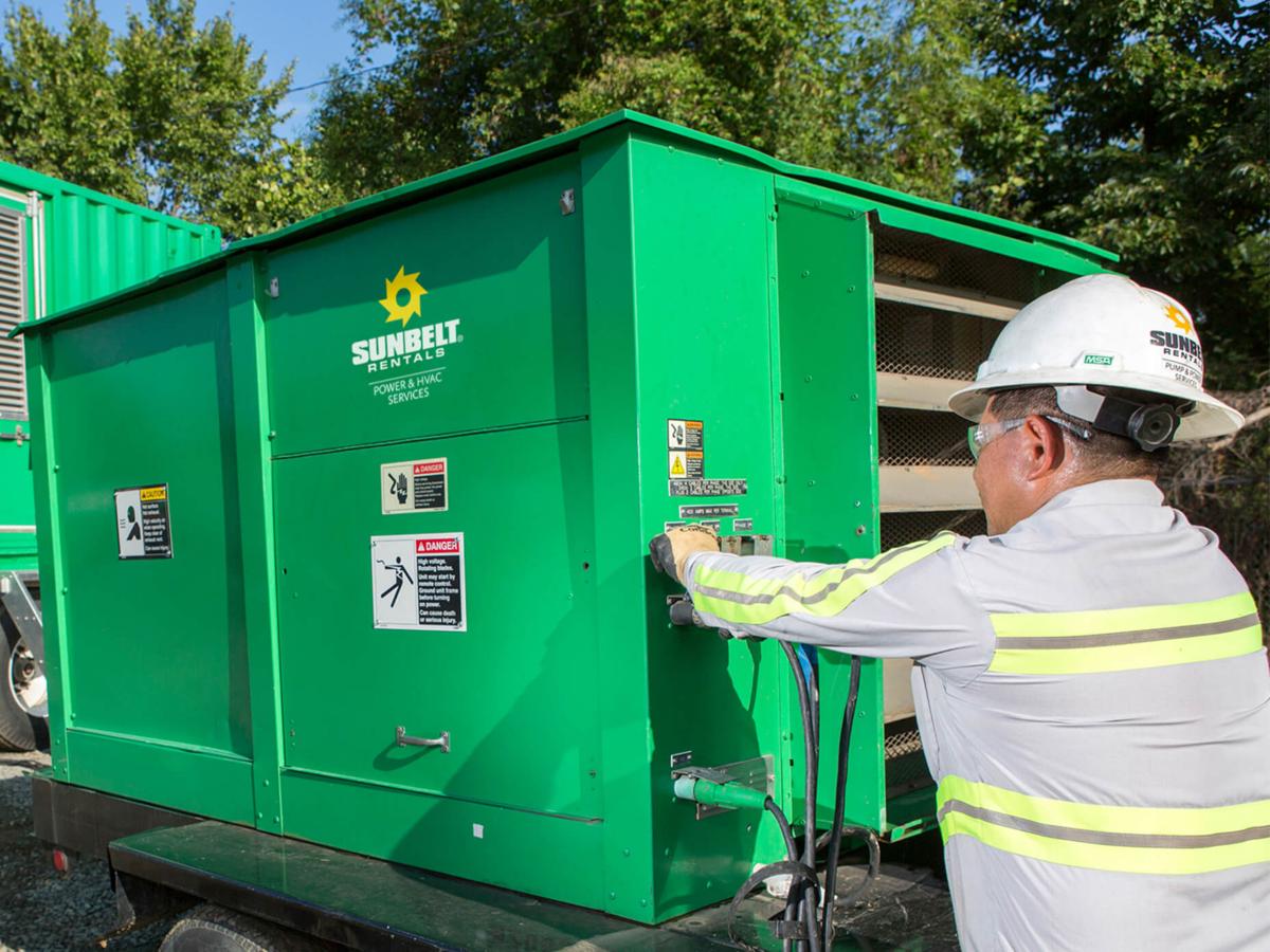 Someone wearing safety apparel works to load test a generator.