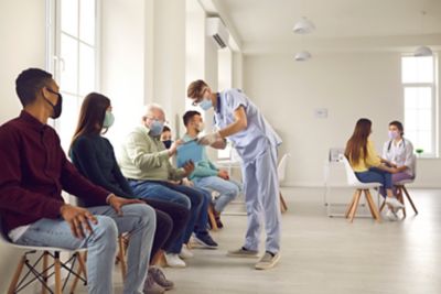 People sitting in the waiting room of a healthcare facility.