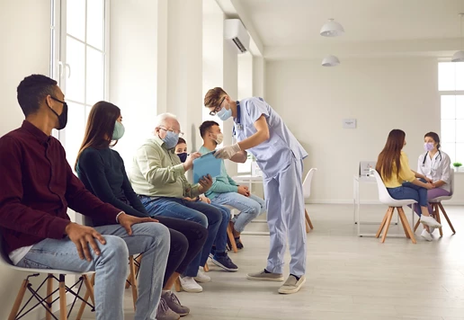 People sitting in the waiting room of a healthcare facility.