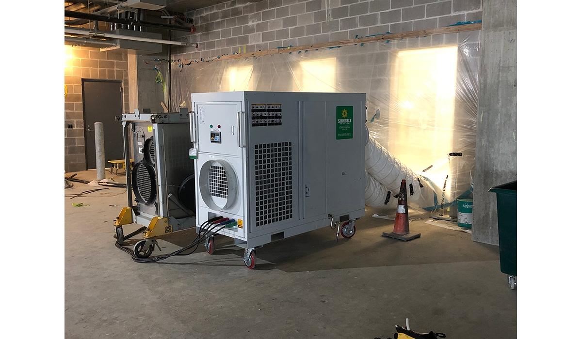 Portable air conditioners installed inside of a building under construction.