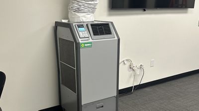 A spot cooler installed inside of a building.