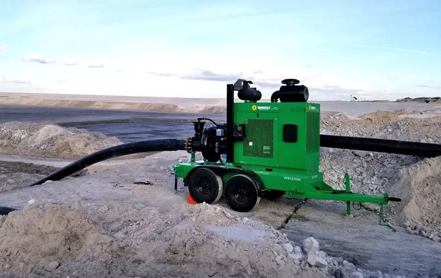 A pump from Sunbelt Rentals installed on sandy terrain.