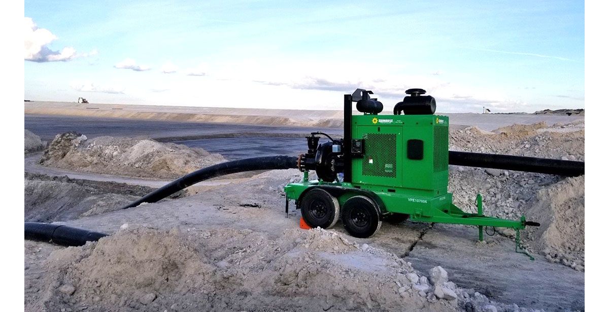 A pump from Sunbelt Rentals installed on sandy terrain.