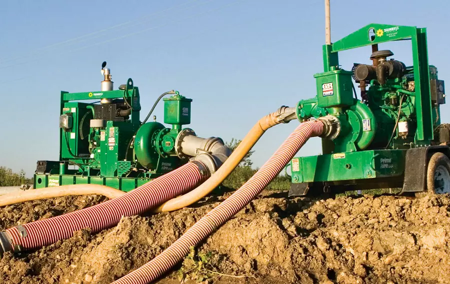 Two high head pumps from Sunbelt Rentals installed at a dirt construction site. 