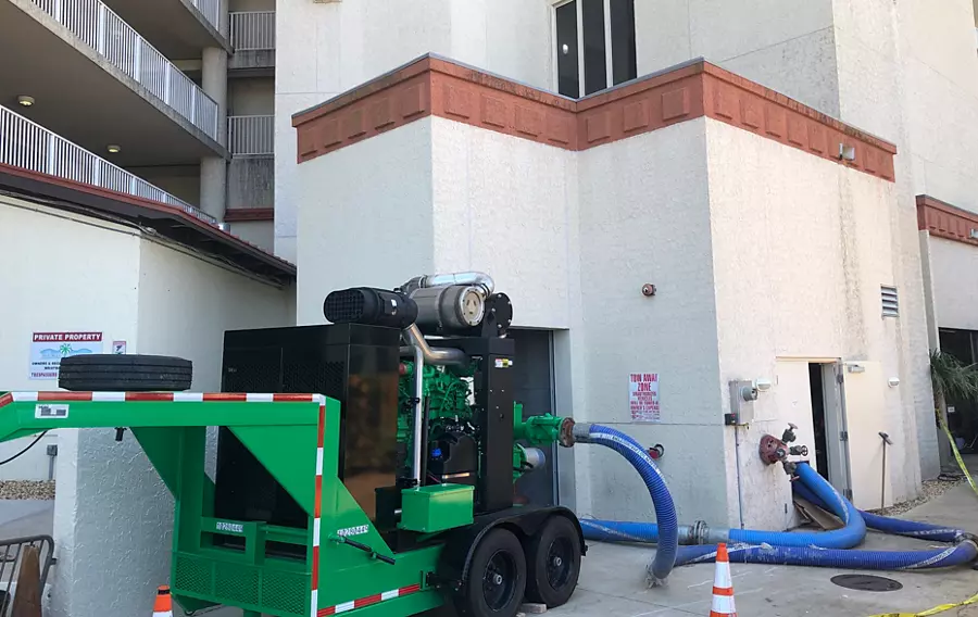A high head pump installed outside of a tall, multi-story building.