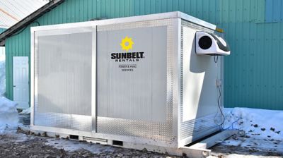 A walk-in refrigerator outside of a building.