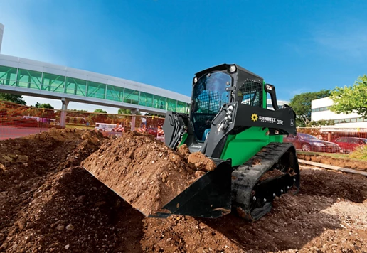 A skid steer loader from Sunbelt Rentals moving dirt at a construction site.