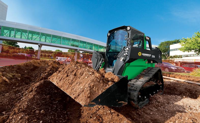 A skid steer loader from Sunbelt Rentals moving dirt at a construction site.