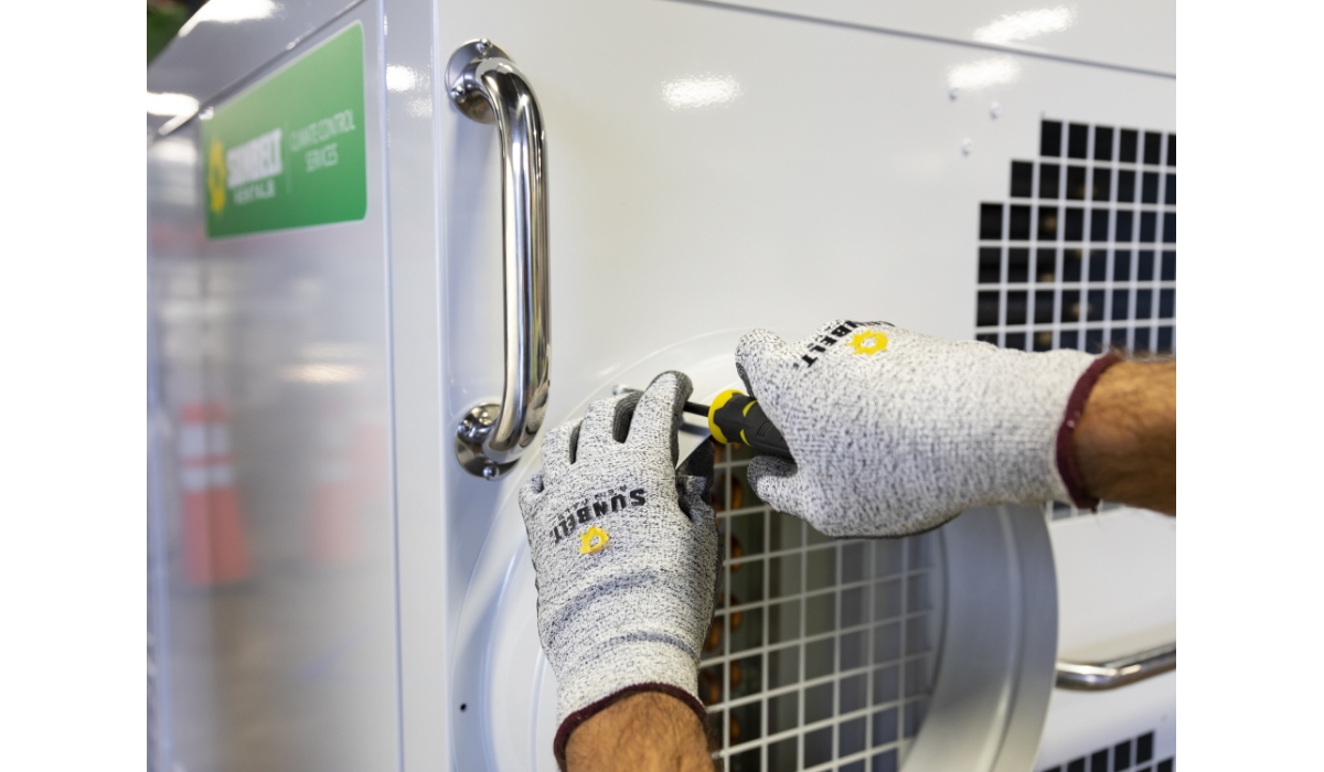 A Sunbelt Rentals technician performing maintenance on HVAC equipment.