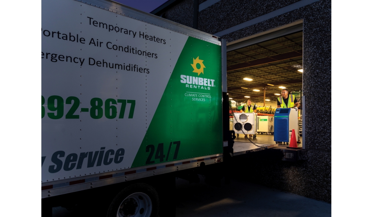 Sunbelt Rentals warehouse workers loading HVAC equipment onto a truck.