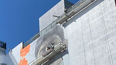 Suspended scaffolding on the side of a building.