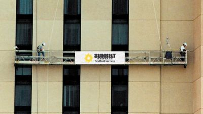 Sunbelt Rentals workers on swing stage scaffolding.