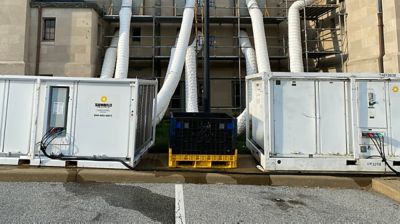 Temporary air conditioning units installed outside of a building under construction.