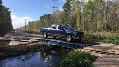 A truck driving over a road plate.