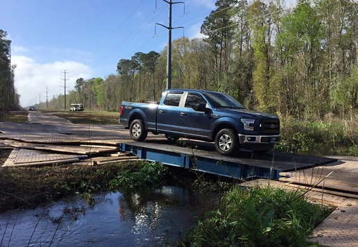 A truck driving over a road plate.