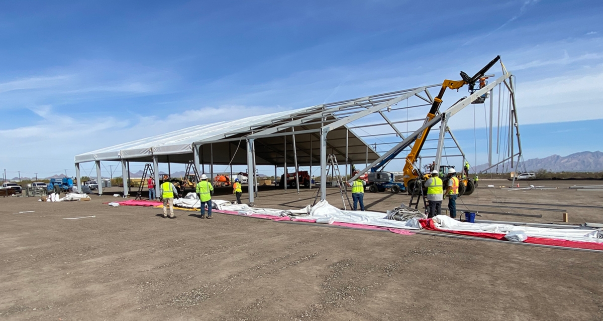 A crew installing a fabric structure.