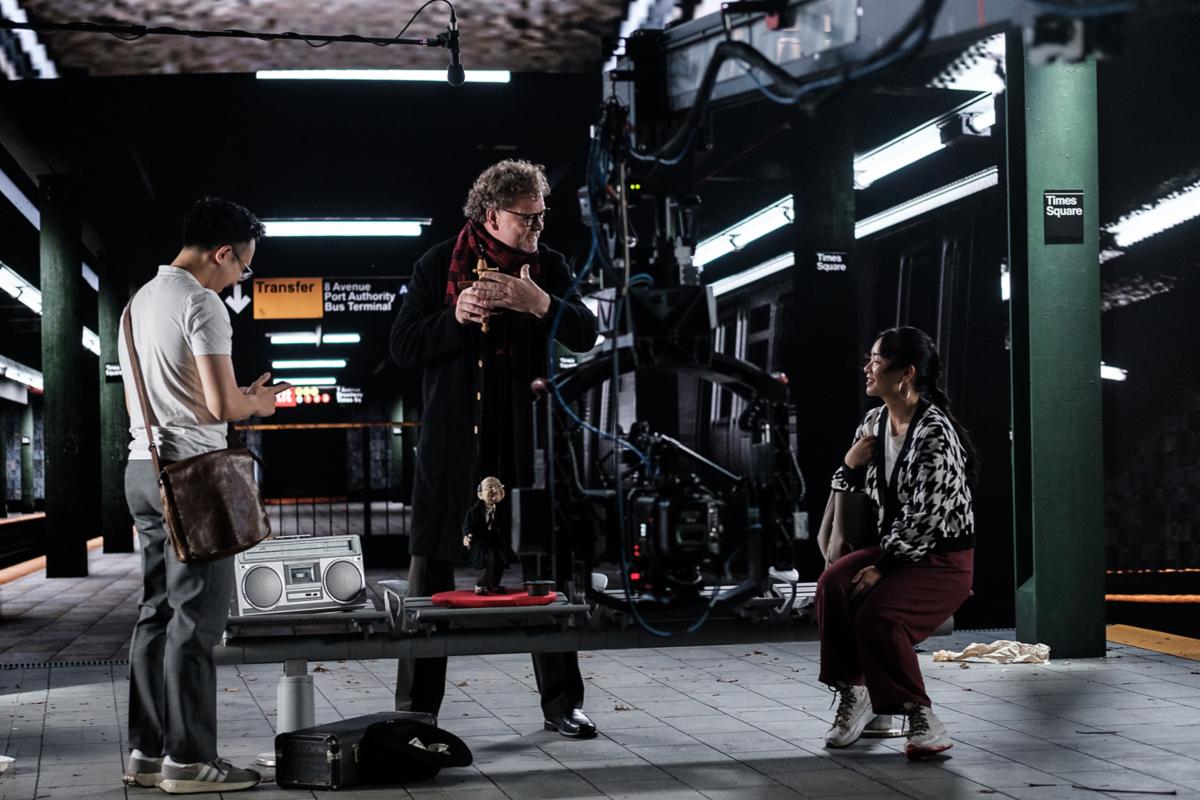 A mentor with filmmakers at a subway.