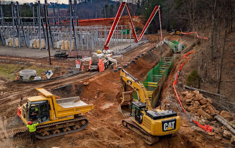 People wearing safety apparel work in and around a sheet and frame system.