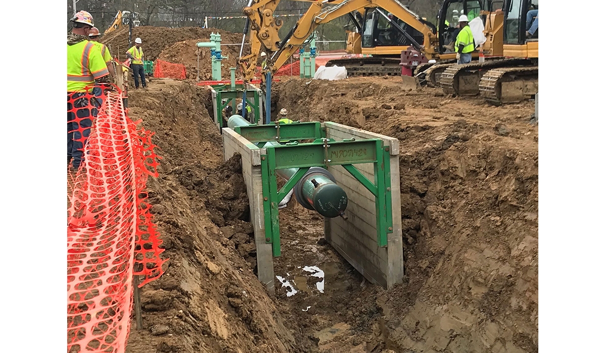 Pipeline trench construction with heavy machinery on a job site.