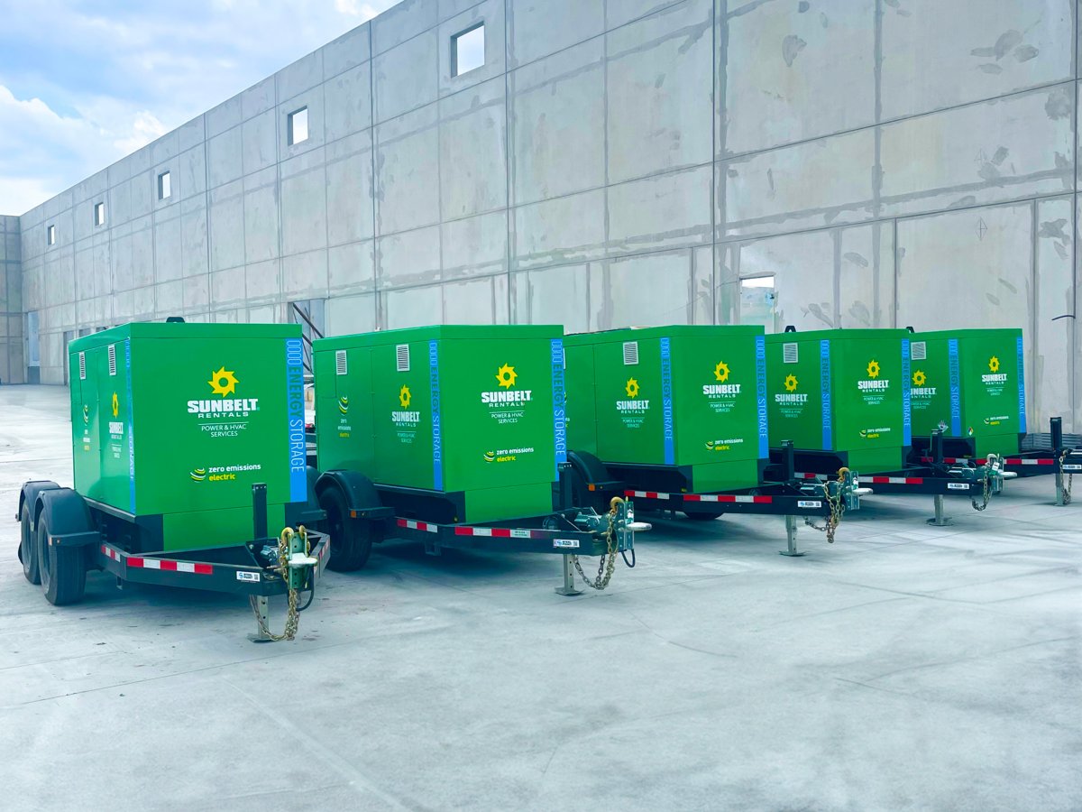 A row of Sunbelt Rentals BESS units in an outdoor industrial setting.