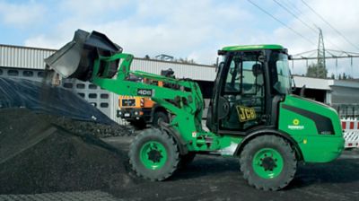 A wheel loader moving dirt at a job site.