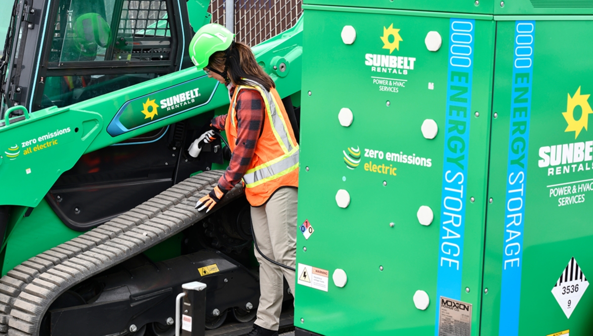 Someone working next to a battery energy storage system from Sunbelt Rentals.