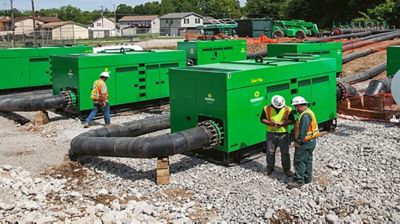 People working around pumps at a construction site.